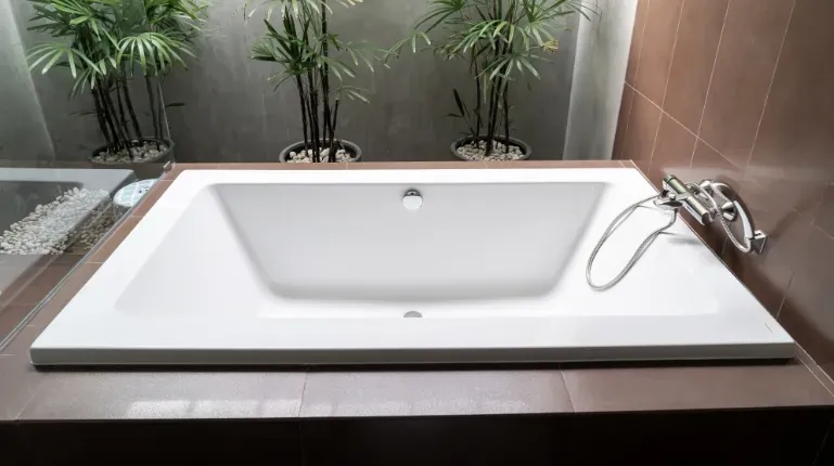 built-in bathtub with brown tiles